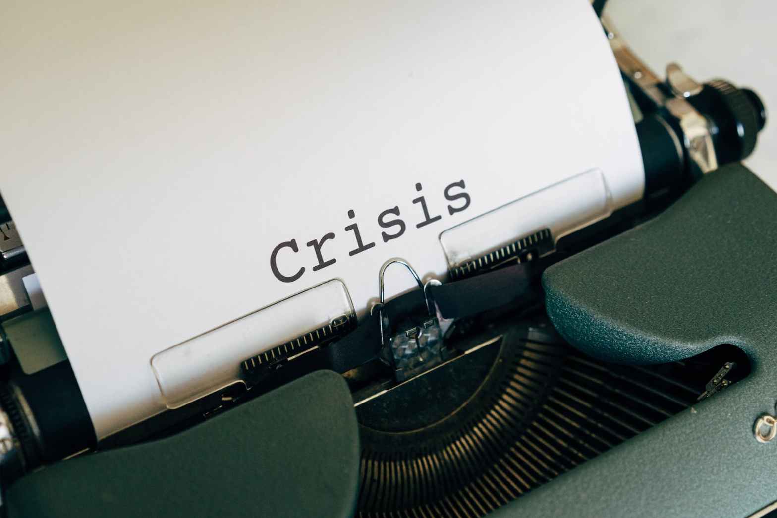 white paper on a vintage typewriter for an article on coming up with a plan for crisis communications. See examples of crisis communications and create a crisis communications template before calamity strikes your business.