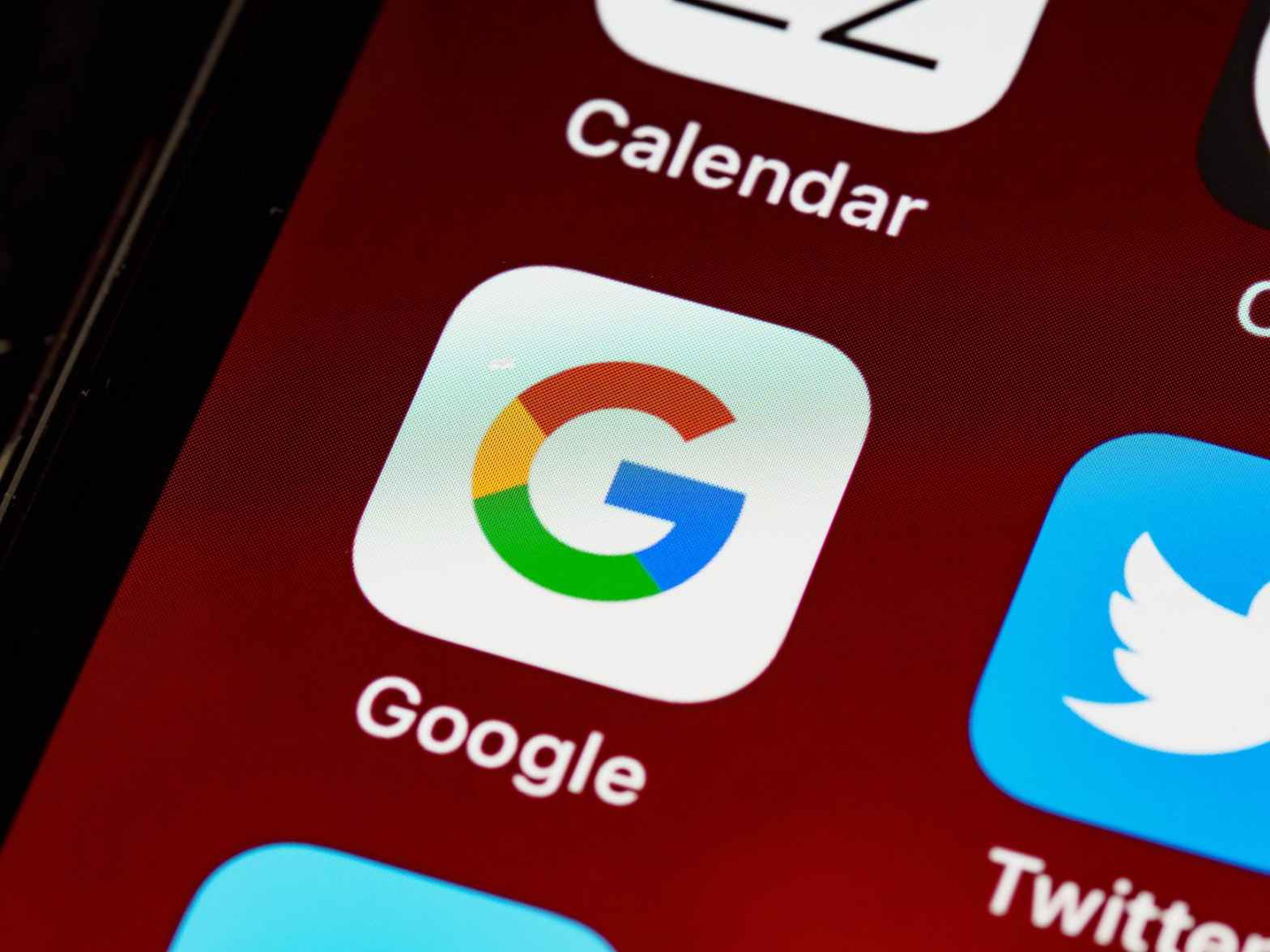 google app icon on a smartphone for a blog article about how to write google ads