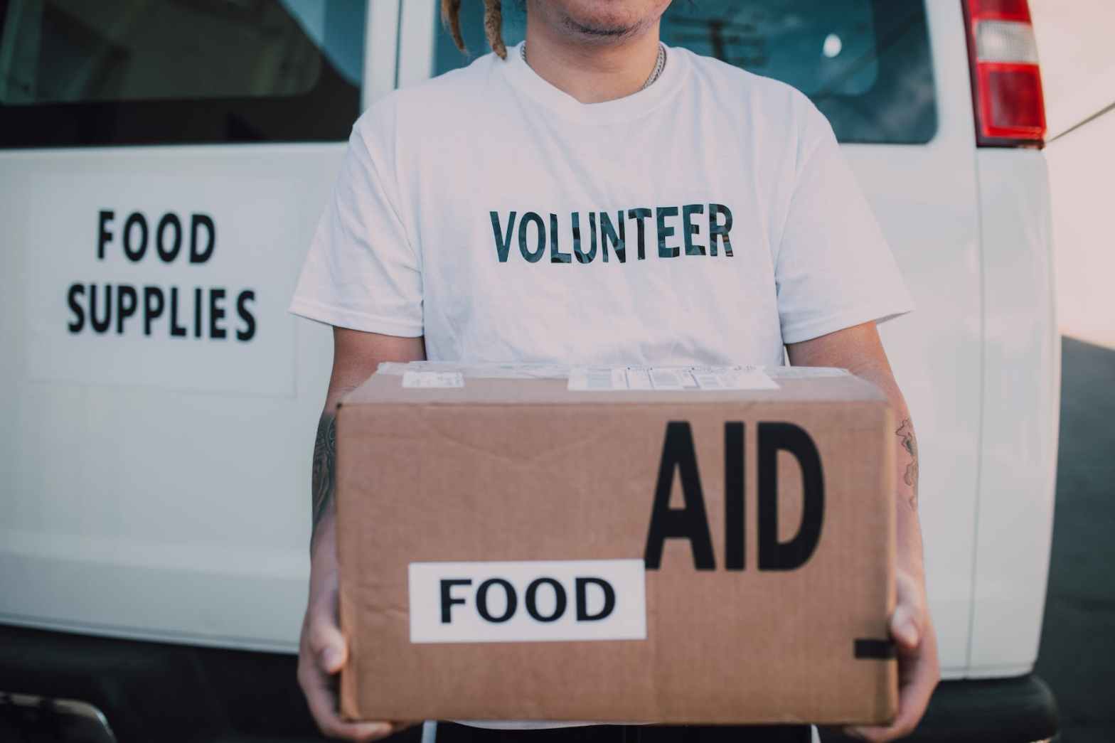 volunteer holding box of food aid for a blog post about copywriting for nonprofits
