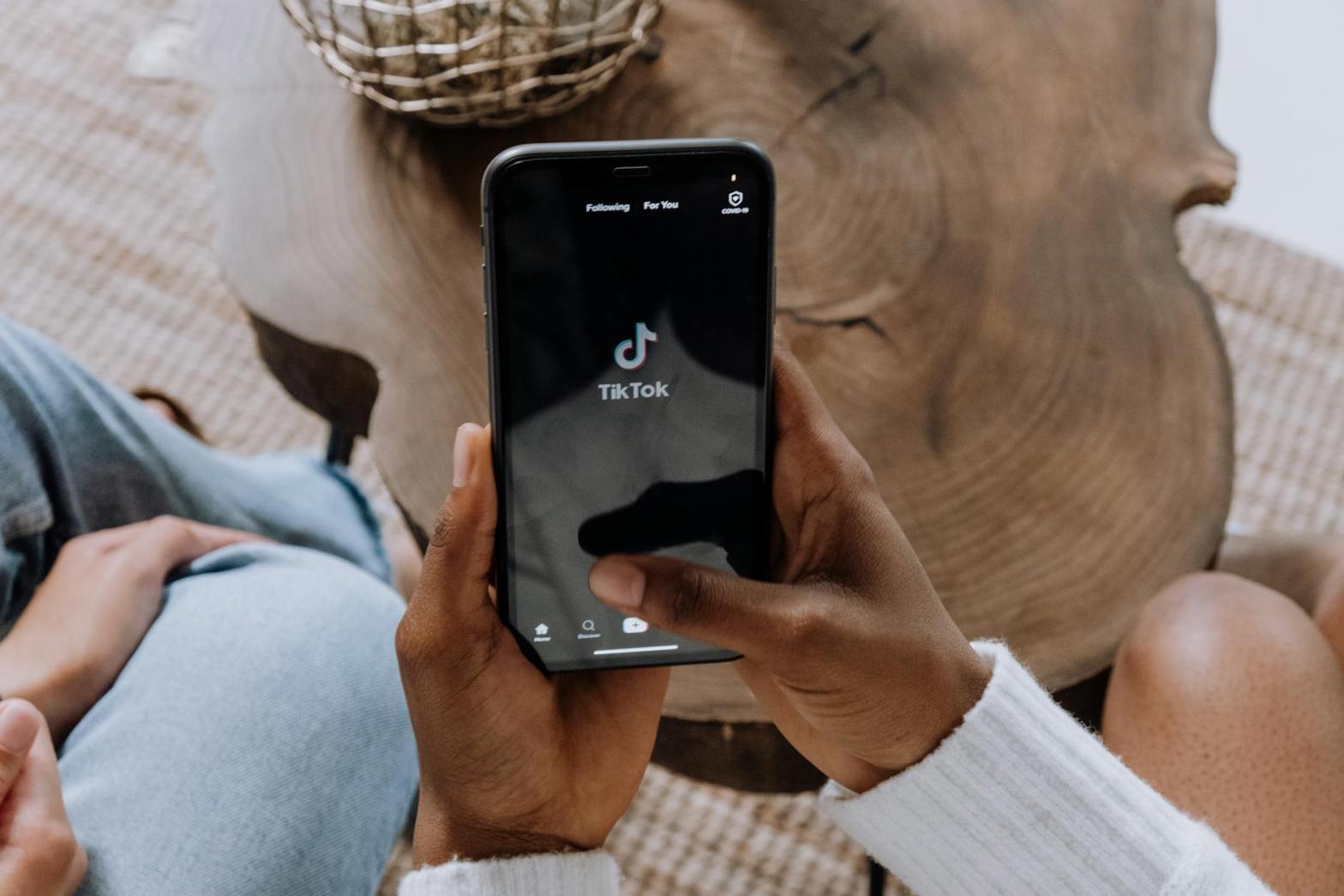 person holding black android smartphone with tiktok app opened for a blog post on whether business executives should use tiktok for personal brand building